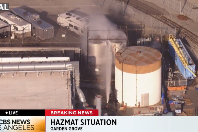 A photo of a giant tank with smoke and chemical coming out of it. On the photo it says, "CBS News Los Angeles: Hazmat Situation"