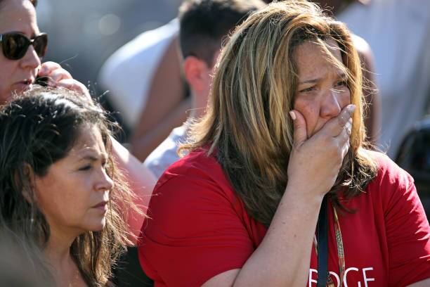 Waiting for word from students at Coral Springs Drive and the Sawgrass Expressway just south of the campus of Stoneman Douglas High School in Parkland, Fla., after a shooting on Wednesday, Feb. 14, 2018. (Amy Beth Bennett/Sun Sentinel/TNS via Getty Images)