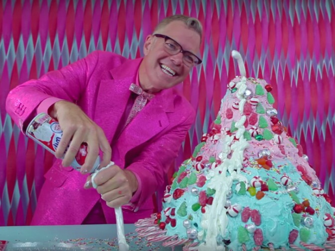 A screenshot show Charles Phoenix in the Test Kitchen with the Christmas Candy Volcano Cake.