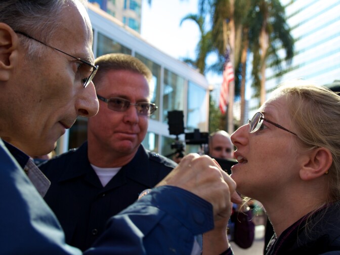 Dominic Peppe (L) argues with Occupy LA organizer Cheryl Aichele (R) after Peppe expressed his contempt for the group. 