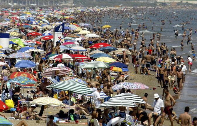 This photo taken 07 August 2003 shows the crowded Malvarrosa beach in Valencia city as Spain as been suffering from a heat wave. At least thirteen people died from an intensive heat wave.         (Photo credit should read JOSE JORDAN/AFP/Getty Images)