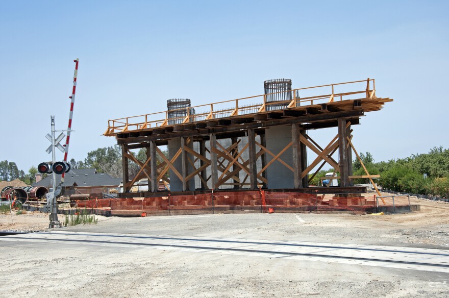 MADERA, CA - JULY  13: (EDITORIAL USE ONLY) In this handout image provided by the California High-Speed Rail Authority, Construction of the north abutment overcrossing that will carry traffic over future high-speed and existing BNSF rail lines outside the town on July 13, 2017 in Madera, California.  the high speed train is supposed to run between SF and Anaheim at a cost of $64 billion. (Photo by California High-Speed Rail Authority via Getty Images)