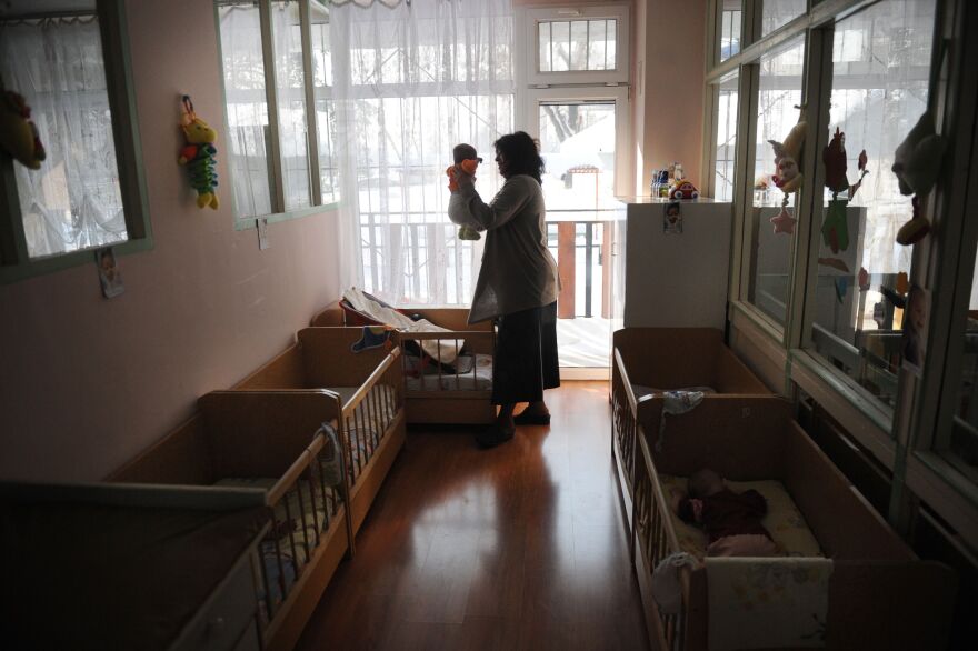 TO GO WITH AFP STORY by Vessela Sergueva.Picture taken on on February 15, 2012,  shows Valentina Liharska, manager of the Saint Ivan Rilski home for medical and social care for children, holding a baby at the home during a visit of United Nations Children's Fund (UNICEF) representatives in Sofia. A practice inherited from communist times, the abandonment of healthy and disabled children by their families is most widespread in the 22 countries of central and eastern Europe, including the former Soviet Union, according to UNICEF mission chief Jean-Claude Legrand.   AFP PHOTO / NIKOLAY DOYCHINOV (Photo credit should read NIKOLAY DOYCHINOV/AFP/Getty Images)