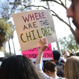 LOS ANGELES, CA - JUNE 14:  A protestor holds a sign at the 'Families Belong Together March' against the separation of children of immigrants from their families on June 14, 2018 in Los Angeles, California. Demonstrators marched through the city and culminated the march at a detention center where ICE (U.S.Immigration and Customs Enforcement) detainees are held. U.S. Immigration and Customs Enforcement recently arrested 162 undocumented immigrants during a three-day operation in Los Angeles and surrounding areas.  (Photo by Mario Tama/Getty Images)