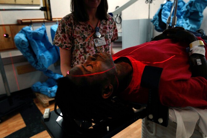 FAYETTEVILLE, NC - AUGUST 04:  Cancer patient Joseph Durant (bottom) lays down before targeted radiation treatment at the Cape Fear Valley Cancer Center August 4, 2010 in Fayetteville, North Carolina. Health care providers around the country are increasingly specializing their care by creating distinct treatment centers for various disorders and acquiring the latest high-tech medical equipment.   (Photo by Chris Hondros/Getty Images) *** Local Caption *** Joseph Durant