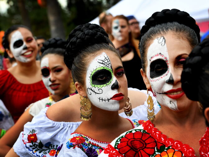 People in costume parade during the annual Dia de los Muertos (Day of the Dead) festival at the Hollywood Forever cemetery in Hollywood, California on October 29, 2016.
Dia de los Muertos is a festival to remember friends and family members who have died and is celebrated throughout Mexico and by people of Mexican heritage living in the United States. / AFP / Mark RALSTON        (Photo credit should read MARK RALSTON/AFP/Getty Images)