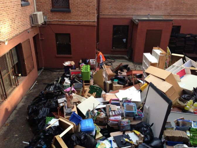 Workers at the Guardian Angel School and Church in the Chelsea neighborhood of Manhattan bring classroom debris to the courtyard from the classrooms. Because of salt water damage everything is beyond repair and will have to be thrown out.
 