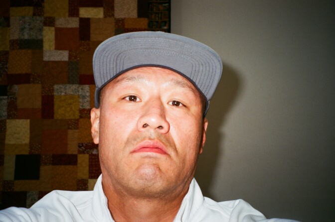 A selfie shows Wooyong Choi in a gray ball cap.