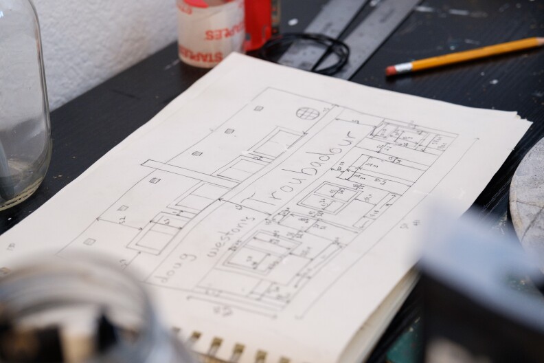 A close-up of Kieran Wright's sketchbook that's opened to his drawings for the Troubadour.