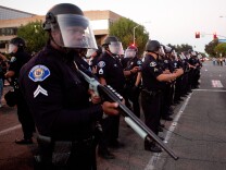 ANAHEIM, CA - JULY 24: A scrimmage line of police officers protect the streets surrounding Anaheim City Hall during a demonstration to show outrage for the fatal shooting of Manuel Angel Diaz, 25, at Anaheim City Hall on July 24, 2012 in Anaheim, California. Diaz was fatally shot on July 21 by an Anaheim police officer and has sparked days of protests by the angered community. (Photo by Jonathan Gibby/Getty Images)