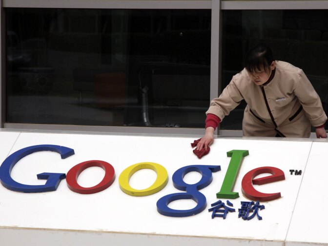A Chinese worker cleans the Google logo at the Google China headquarters in Beijing on Monday.
