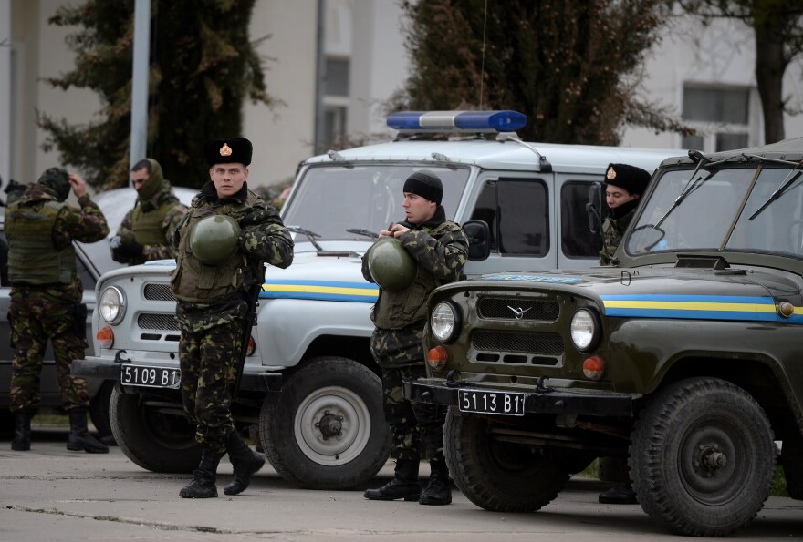 Soldiers stand inside the Belbek airbase, not far from Sevastopol on March 6, 2014. Ukrainian premier Arseniy Yatsenyuk on Thursday dubbed as illegitimate a request by the local parliament in Crimea to become part of Russia.