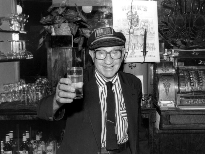 The late proprietor toasts photographer Gary Leonard at Hank's Bar in downtown Los Angeles.