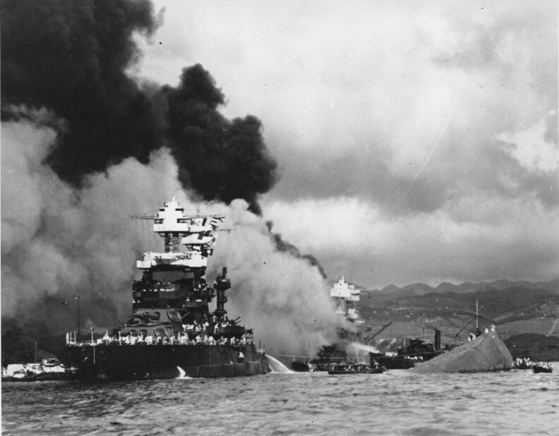 File: in this Dec. 7, 1941 file photo, the battleship USS West Virginia, center, begins to sink after suffering heavy damage, while the USS Maryland, left, is still afloat in Pearl Harbor, Oahu, Hawaii. The capsized USS Oklahoma is at right.