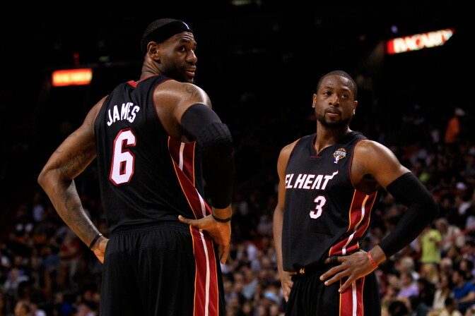 LeBron James #6 and Dwyane Wade #3 of the Miami Heat look on during the game against the Orlando Magic at American Airlines Arena on March 6, 2013 in Miami, Florida.