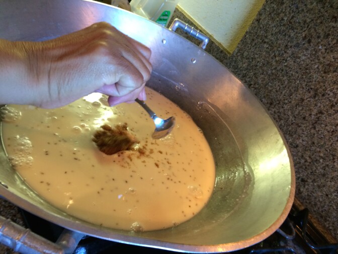 Simmering coconut milk and anise seeds in the kiwali, or large pan, for the Filipino dish ube halaya.