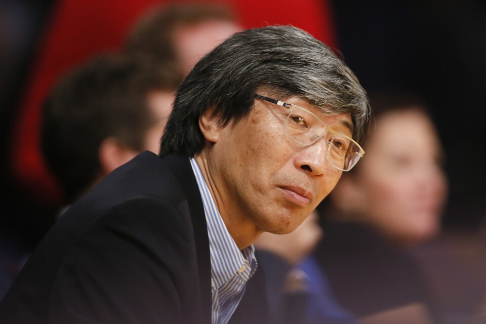 Dr. Patrick Soon-Shiong sits courtside as the Los Angeles Lakers play against the Utah Jazz during the second half of an NBA basketball game in Los Angeles, Tuesday, Feb. 11, 2014. The Jazz won 96-79. (AP Photo/Danny Moloshok)