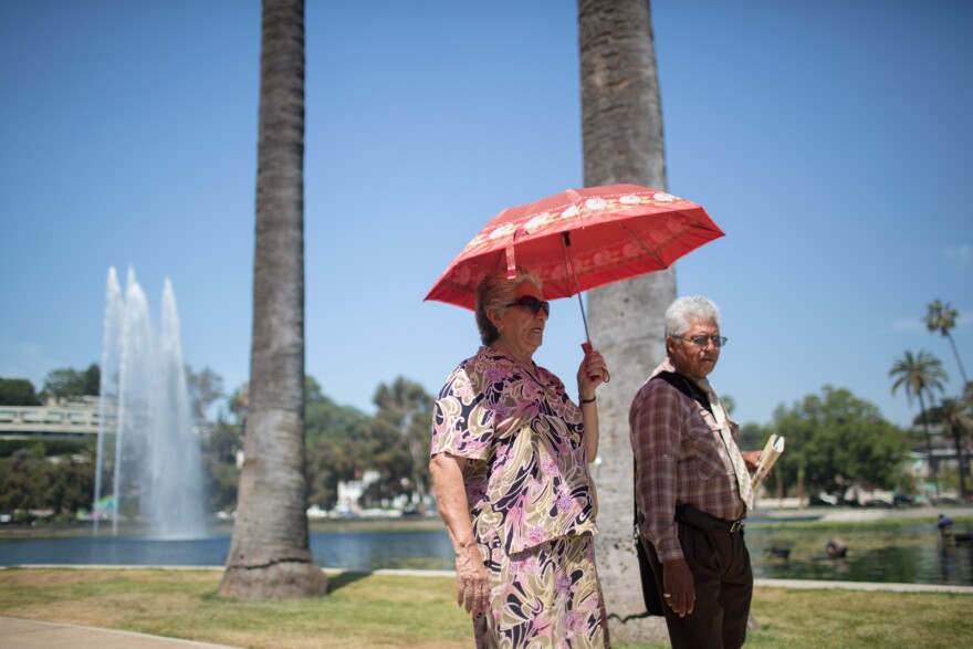 A man and woman walk around Echo Park Lake on June 28, 2013.