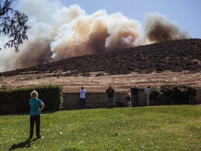 Residents watch a brushfire burn in the unincorporated Newbury Park neighborhood west of Thousand Oaks in Ventura County on May 2, 2013.