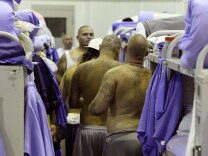 IONE, CA - AUGUST 28:  Inmates at the Mule Creek State Prison crowd between bunk beds in a gymnasium that was modified to house prisoners August 28, 2007 in Ione, California. A panel of three federal judges is looking to put a cap on the California State Prison population after class action lawsuits were filed on behalf of inmates who complained of being forced to live in classrooms, gymnasiums and other non-traditional prison housing. California prisons house nearly 173,000 inmates with over 17,000 of them in non-traditional housing. The Mule Creek State Prison has had to modify several facilities to make room for an increasing number of inmates. (Photo by Justin Sullivan/Getty Images)