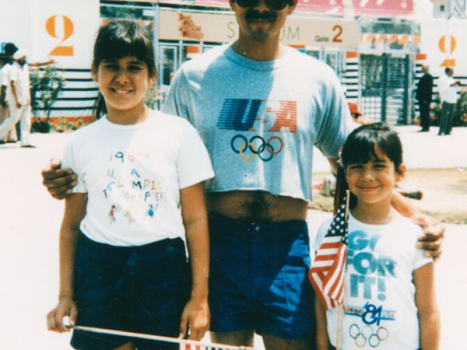 Colette and Julie with their father Julian attend an event at the summer Olympic Games. 