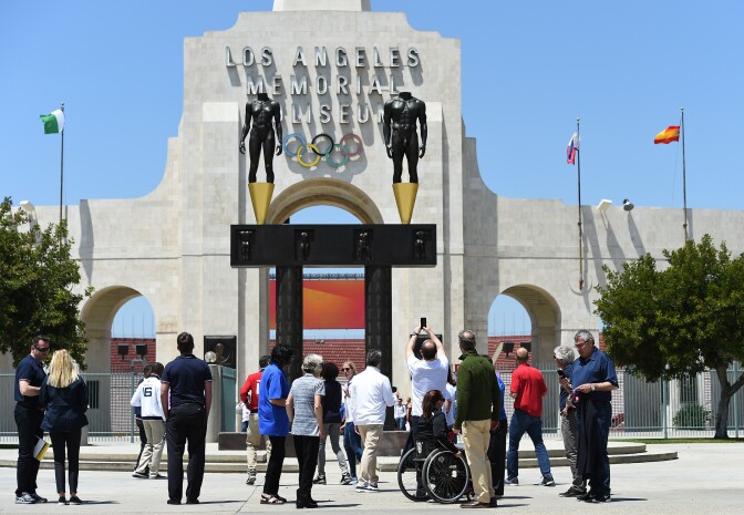 IOC Evaluation Commission Chairman Patrick Baumann (C) takes a photograph of the Los Angeles Memorial Coliseum with Los Angeles Mayor Eric Garcetti and LA2024 committee members, IOC Evaluation Commission members, Olympic and paralympics athletes in front of Los Angeles Memorial Coliseum after a venue tour May 11, 2017, in Los Angeles.