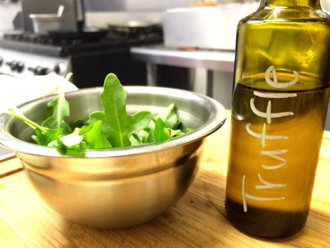 Truffle oil from California to dress the arugula that's on the truffle burger.
