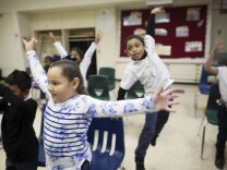 First graders Valeria Beltran, left, and Jarret Moore take part in a music class at Martin Luther King Elementary School in Compton on Friday morning, Dec. 5, 2014. The class is supported by Turnaround Arts, a national program that brings arts education to high-poverty elementary and middle schools.