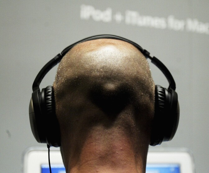 A man listens to music from an iPod.