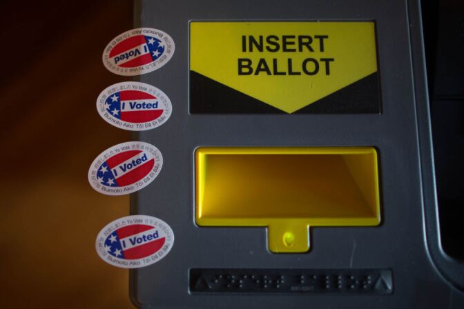 A vote-counting machine and voting stickers.