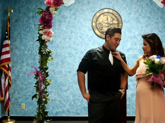 Jessica Garcia straightens her soon-to-be husband's tie before their ceremony in the chapel.