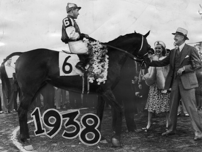 Seabiscuit is shown in the winner's circle after winning the initial running of the $50,000 Hollywood Gold Cup race on July 18, 1938. George Woolf is the jockey, with his owner, Charles S. Howard, and Anita Louise paying homage to the great champ. 