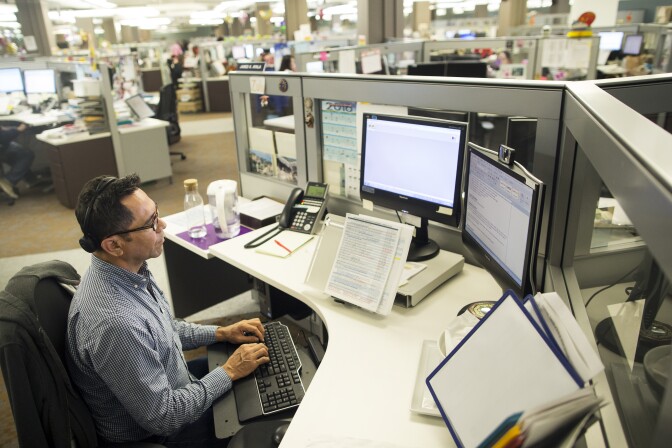 James Ayala, a children's social worker, takes calls to the Child Protection Hotline at the Metro North office of the Los Angeles County Department of Children and Family Services on Friday afternoon, April 8, 2016.