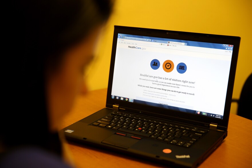 Certified Enrollment Specialist, Yanelis Diaz, waits on the HealthCare.gov website that reads, "HealthCare.gov has a lot of visitors right now!" as she helps people through the options available to them under the Affordable Care Act  at a Miami Enrollment Assistance Center on December 23, 2013 in Miami, Florida.  In a symbolic gesture, U.S. President Obama signed up in the federal health care insurance. 