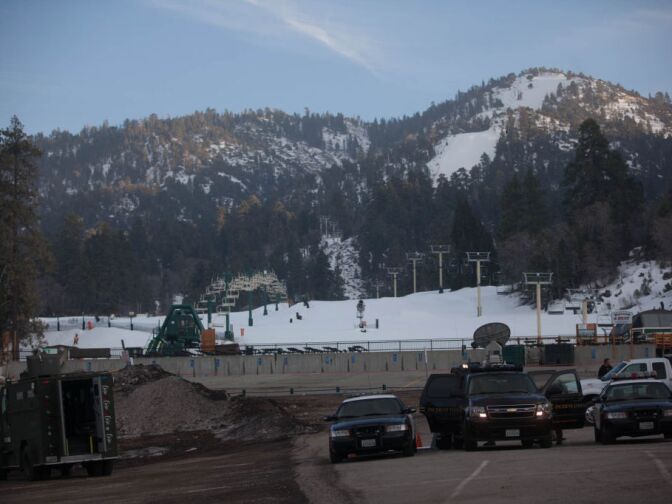 Law enforcement vehicles are parked at the base of Bear Mountain ski resort, which has been closed all day, because of a massive manhunt for Christopher Dorner.