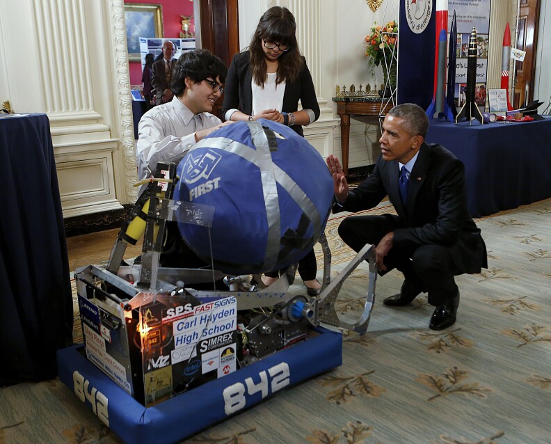 U.S. President Barack Obama looks at the invention of Sergio Corral and Isela Martinez from Phoenix, Arizona, during the 2015 White House Science Fair on March 23, 2015 in Washington, DC.