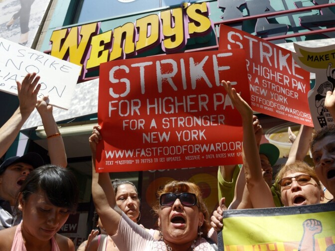 People gathered outside a Wendy's restaurant in New York City on Monday as part of a one-day strike calling for higher wages for fast-food workers.