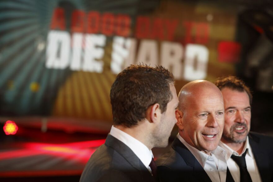 Australian actor Jai Courtney (L), US actor Bruce Willis (C) and German actor Sebastian Koch (R) pose for photographers while arriving for the UK premiere of 'A Good Day To Die Hard', the fifth film in the Die Hard franchise, in central London on February 7, 2013. 