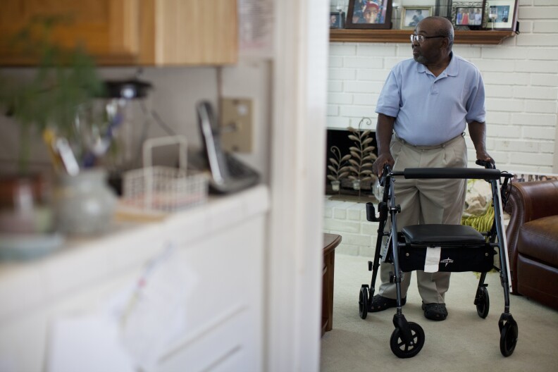 After two unnecessary back surgeries, Azike Ntephe now uses a walker to move around his home. He had to give up his law practice and most outdoor activities as begins to walk on his own again.