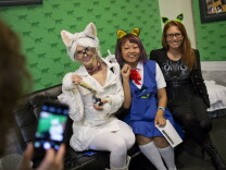 Athena Stamos, left, dressed as Chemistry Cat, Linda Trujillo, dressed as Haru Yoshioka from "The Cat Returns," and Kendra Guffey pose for a photo during the first-ever CatConLA at The Reef on Saturday, June 6, 2015.