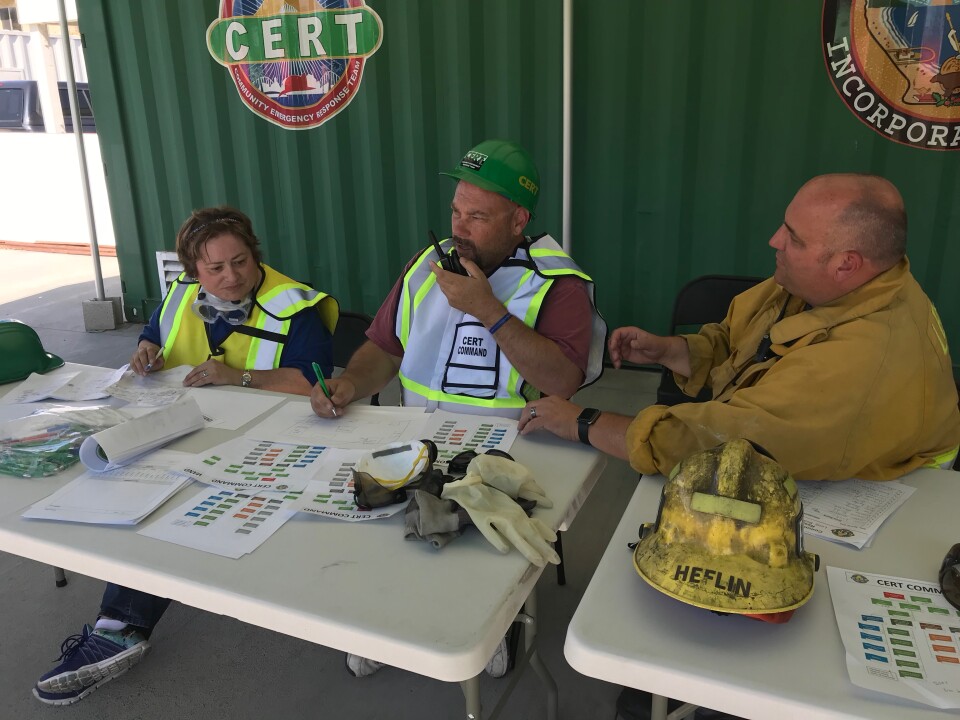 Jake Heflin, a fire fighter and the CERT program manager, helps CERT trainees learn how to run an emergency operations center. Photo credit: Audrey Alden
