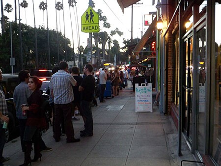 People mingle on a sidewalk in Franklin Village