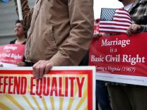 Opponents of Proposition 8, California's anti-gay marriage bill, hold signs outside of the Ninth U.S. Circuit Court of Appeals on February 7, 2012 in San Francisco, California. A three-judge panel of the 9th U.S. Circuit Court of Appeals ruled that the voter-approved Proposition 8 measure violates the civil rights of gay men and lesbians.  