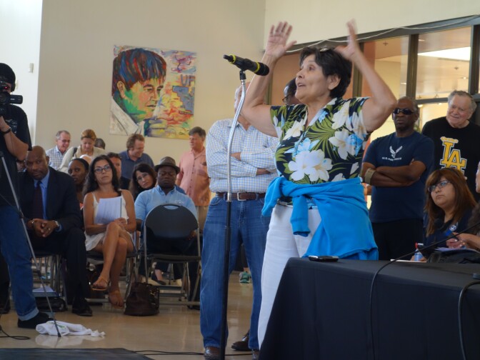 Long Beach resident Marlene Alvarado speaks at the Long Beach town hall meeting about the Southern California Edison power outage Aug. 22, 2015. She has solar power, and wants rules changed that would allow her to store up power in a battery to use in an emergency.