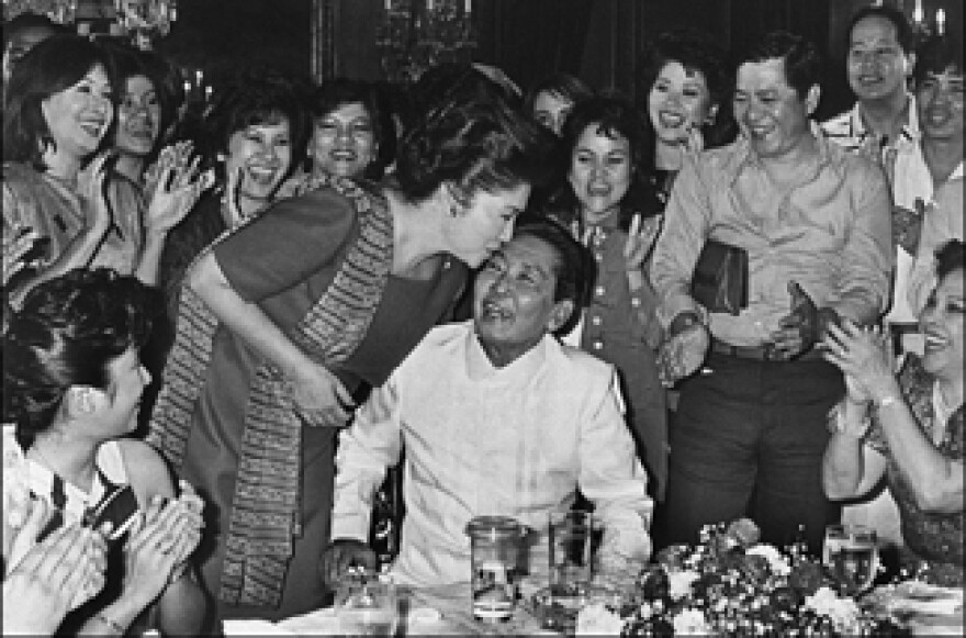 Photo date: February 16, 1986. The late Philippine President Ferdinand Marcos (C) receiving a kiss from his wife Imelda following his victory of the February 7, 1986 presidential elections, at Malacanang presidential palace in Manila.