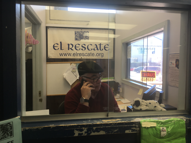 Salvador Sanabria, executive director of El Rescate, works the intake booth one recent Saturday as Central Americans with Temporary Protected Status lined up outside the door for legal screenings. The Trump administration has announced it's ending the protection for Salvadoran and Nicaraguan immigrants; Hondurans will learn their fate soon.