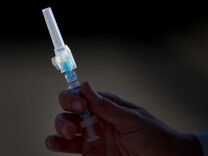 SAN PABLO, CA - NOVEMBER 06:  A nurse holds a syringe filled with flu vaccine during a drive-thru flu shot clinic at Doctors Medical Center on November 6, 2014 in San Pablo, California. Doctors Medical Center hosted a drive-thru flu shot clinic offering free vaccines for any community member over the age of 18.  (Photo by Justin Sullivan/Getty Images)