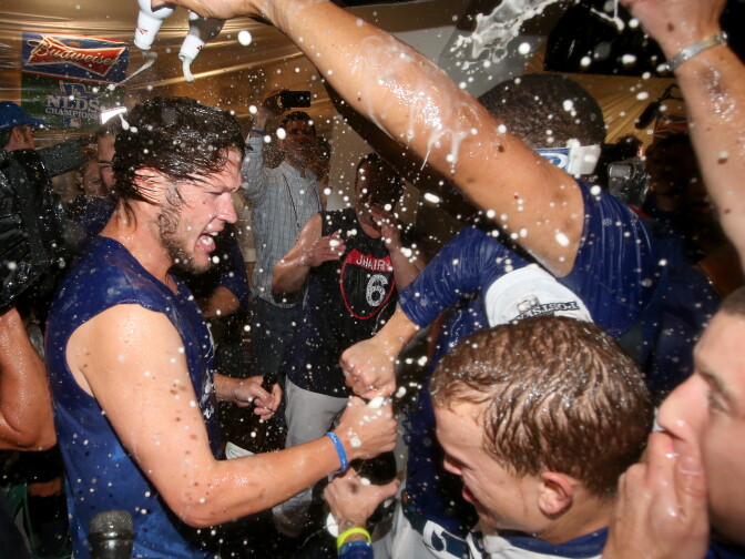Clayton Kershaw #22 of the Los Angeles Dodgers celebrates in the locker room after the Dodgers defeat the Atlanta Braves 4-3 in Game Four of the National League Division Series at Dodger Stadium on Oct. 7, 2013 in Los Angeles.