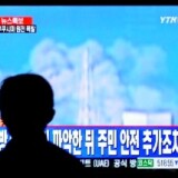 A South Korean passenger watches TV showing Japan's Fukushima No. 1 atomic plant spewing fumes at a railway station in Seoul on March 12, 2011.