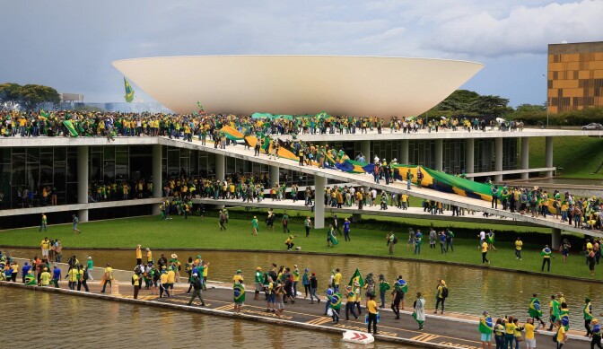People in yellow and green gather at the National Congress in Brasilia on Sunday. 